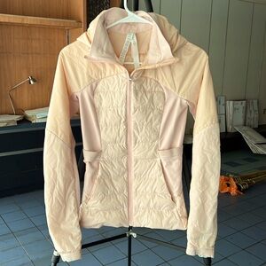 Lightweight hooded puffer jacket from Lululemon, light pink.